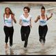 Actresses Lorraine Burroughs, Lily James and Dominique Tipper run along the beach in Cannes to promote Ealing Metro's Fast Girls.